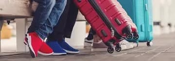 Travelers with suitcases waiting at a bus station